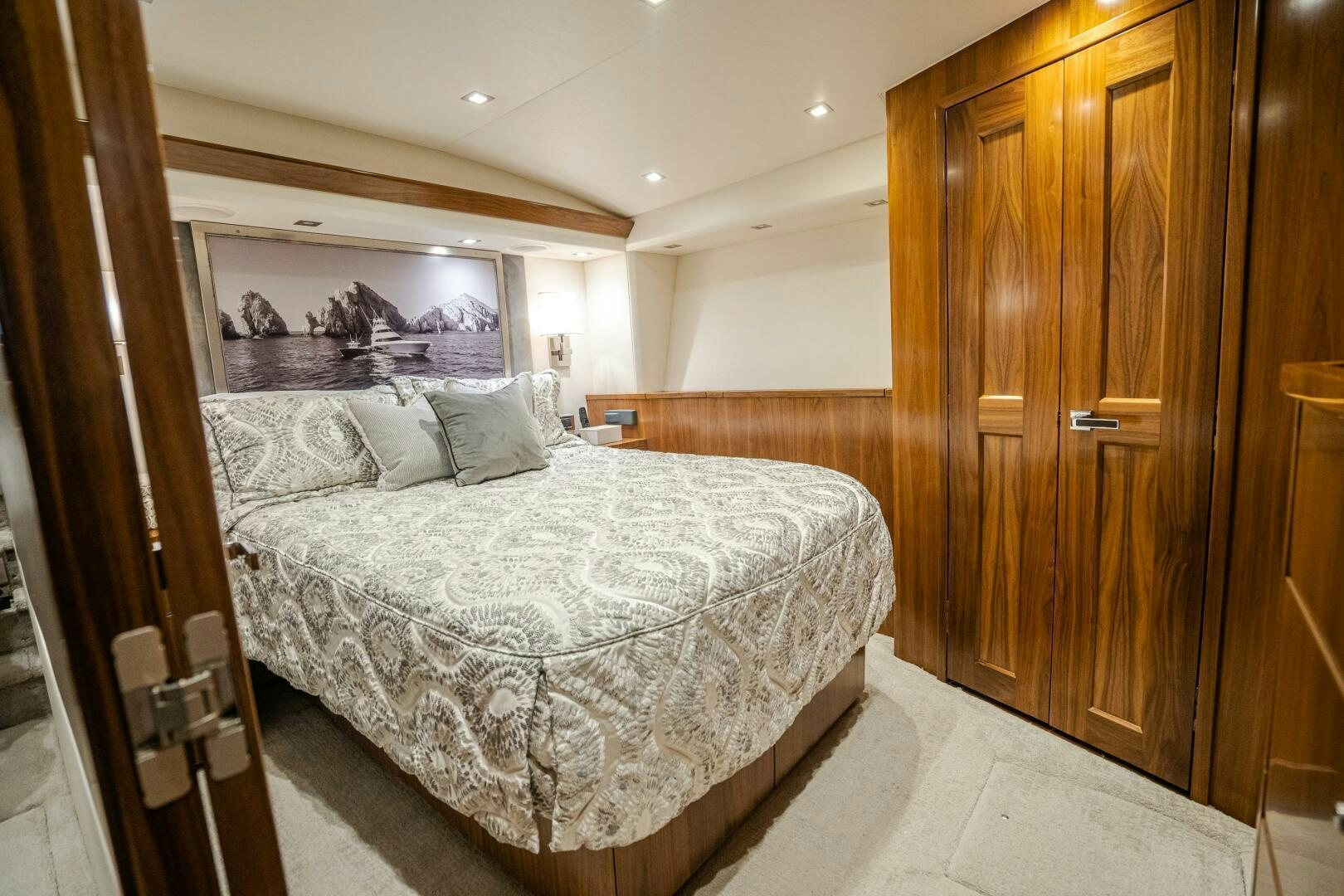 a bedroom with a bed and a closet aboard HOORAY Yacht for Sale