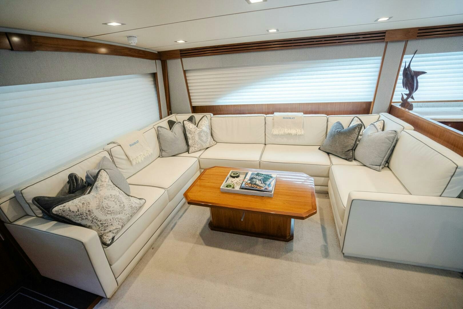a living room with a couch and a coffee table aboard HOORAY Yacht for Sale