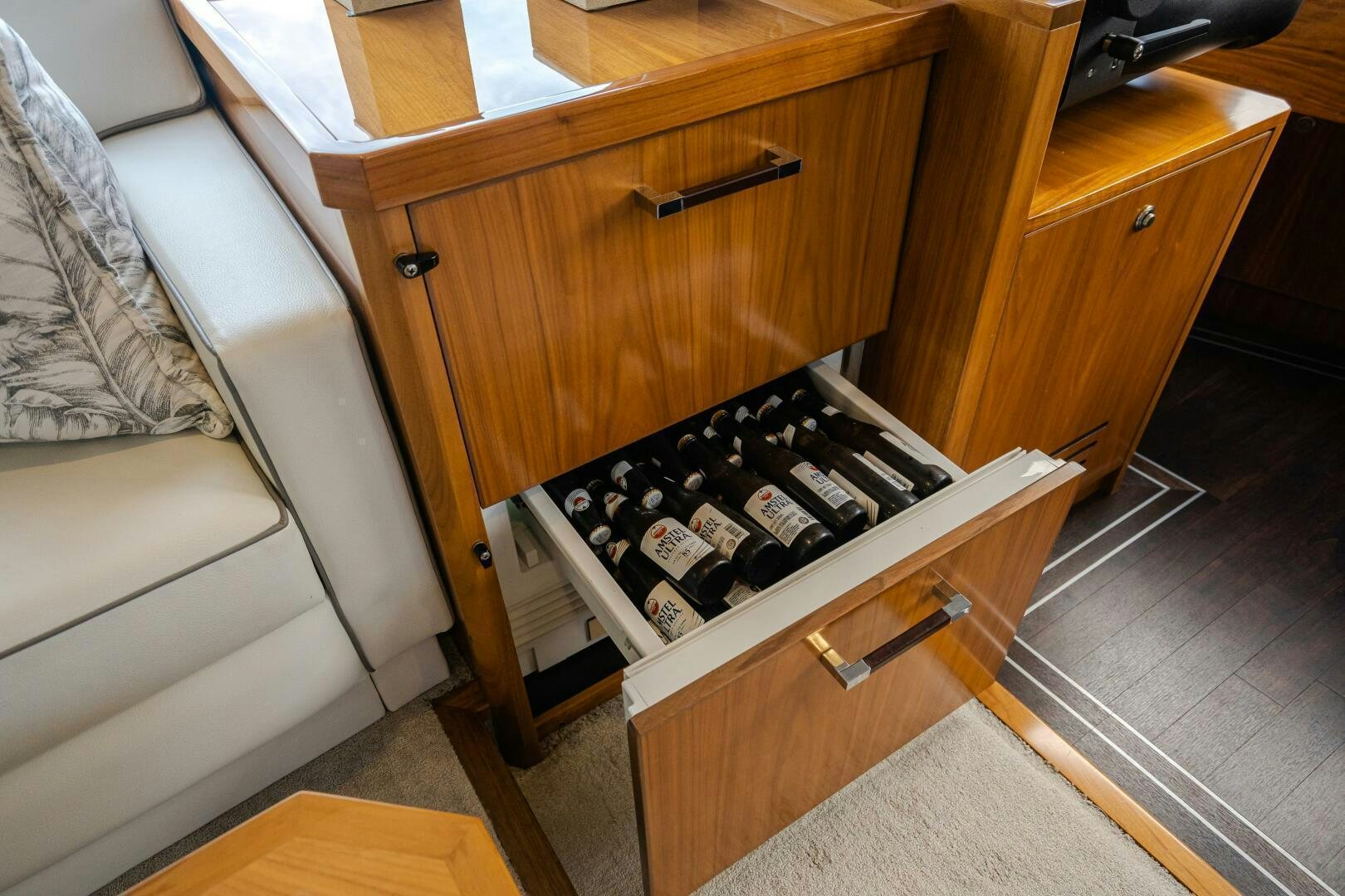 a small wooden cabinet with a black and white keyboard aboard HOORAY Yacht for Sale