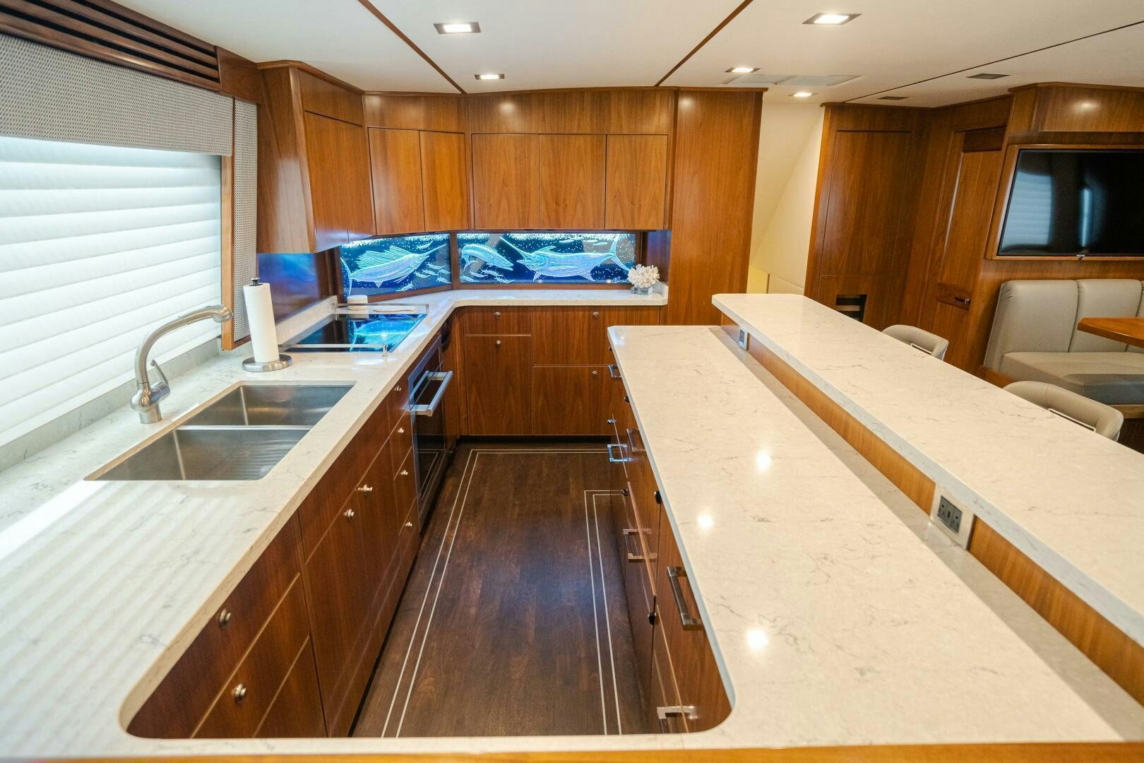 a kitchen with wooden cabinets aboard HOORAY Yacht for Sale