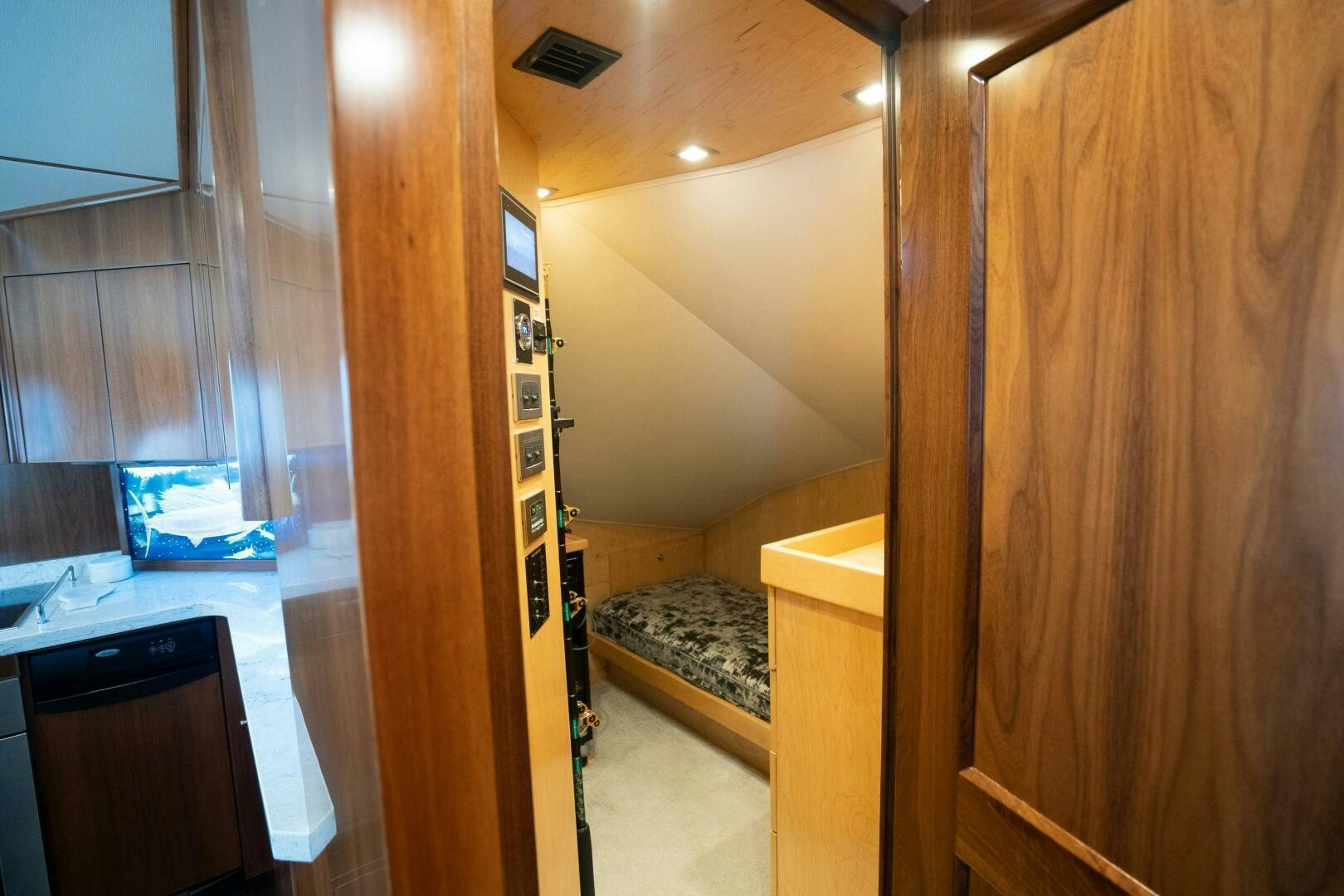 a room with a wood door and a wood cabinet aboard HOORAY Yacht for Sale