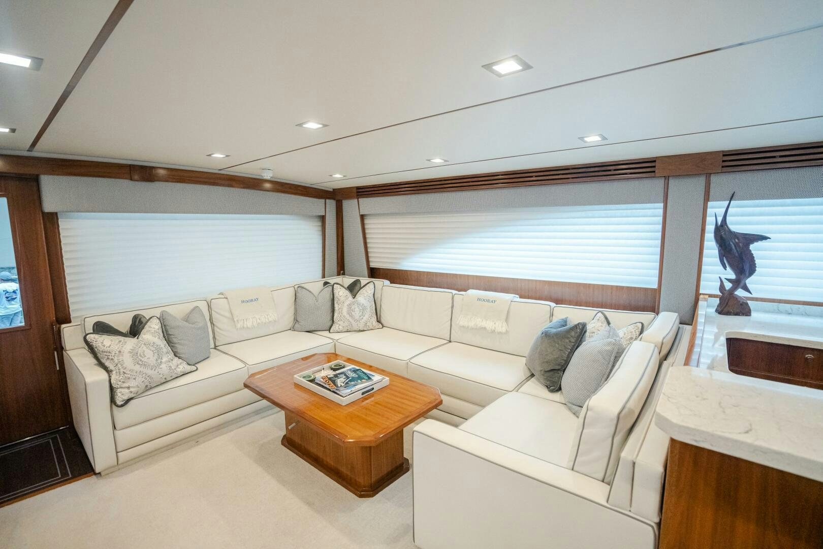 a living room with a couch and a table aboard HOORAY Yacht for Sale