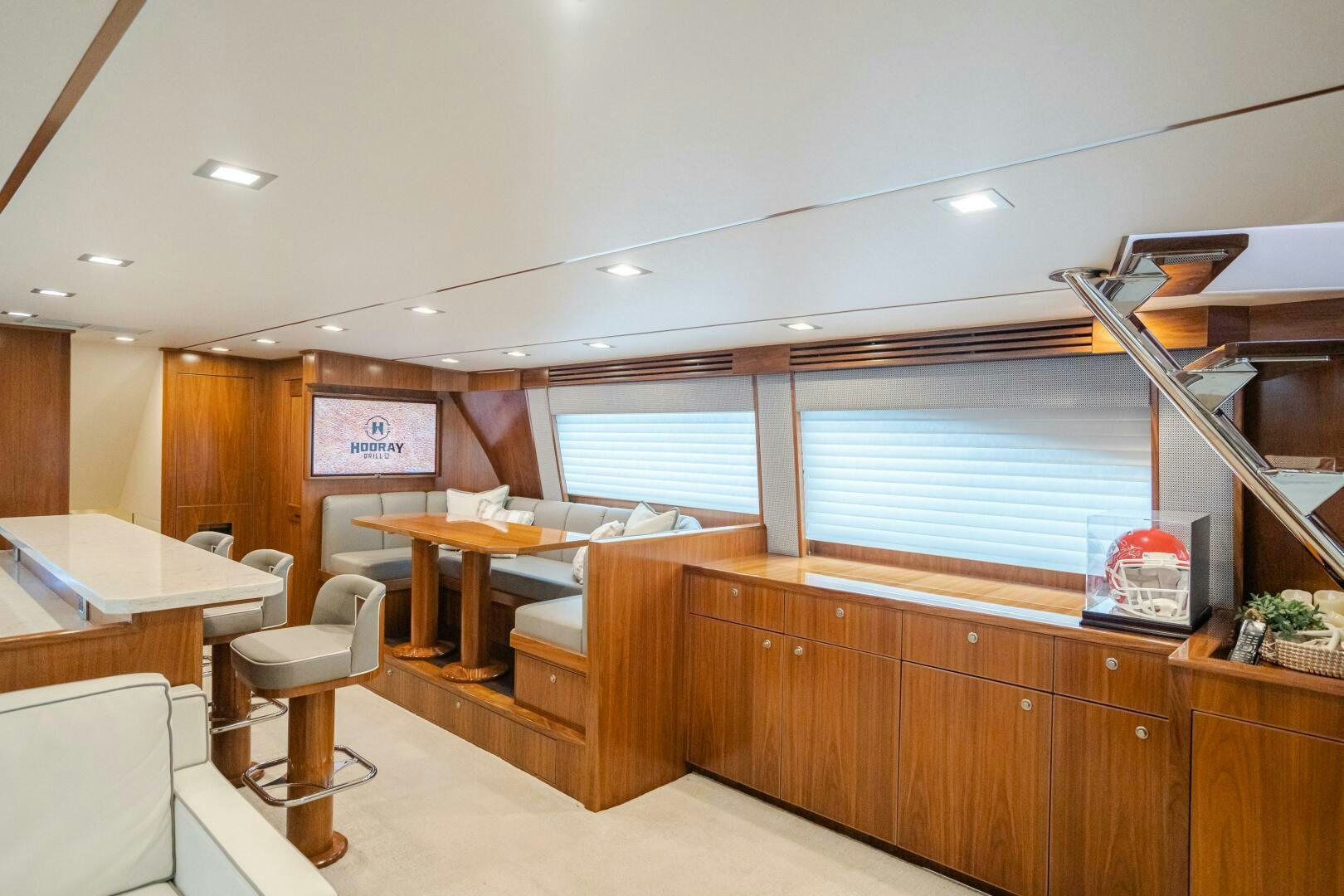 a room with tables and chairs aboard HOORAY Yacht for Sale