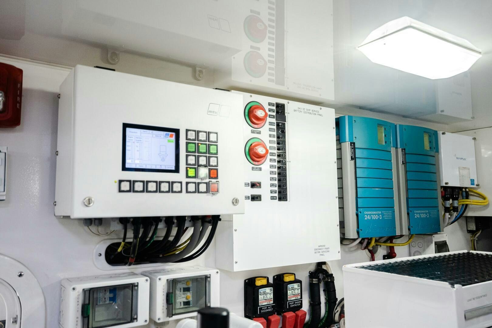 a white paneled room with several computer monitors and a few blue doors aboard HOORAY Yacht for Sale