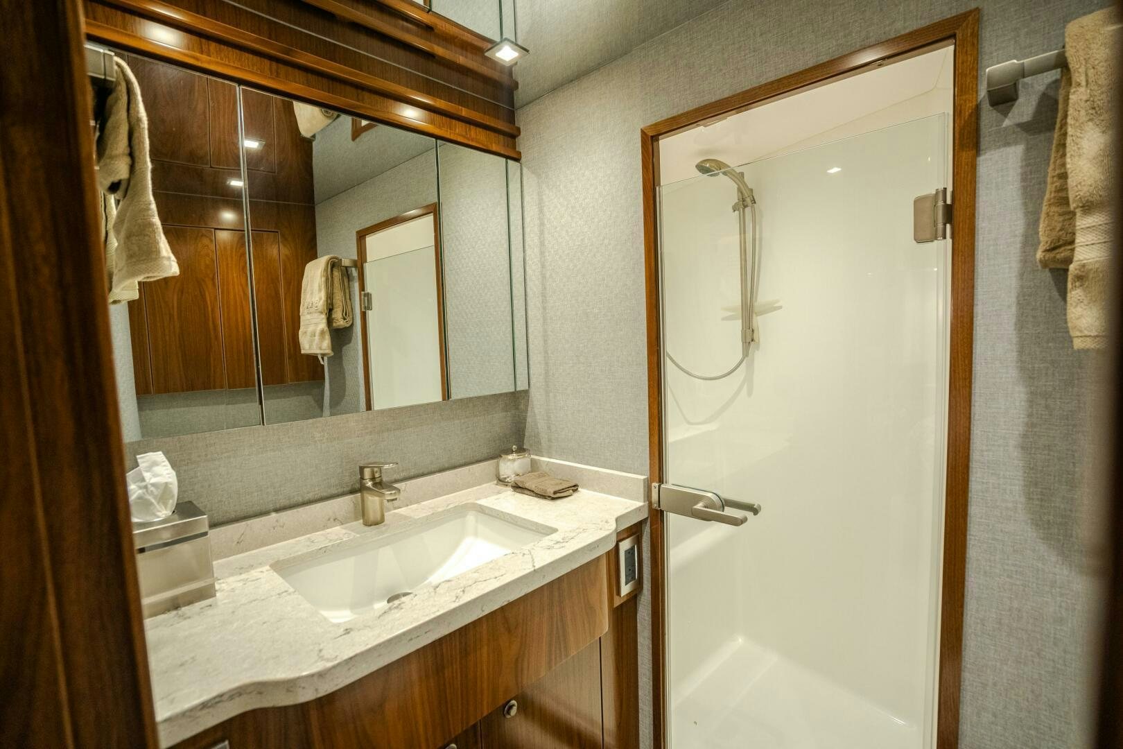 a bathroom with a mirror and a sink aboard HOORAY Yacht for Sale
