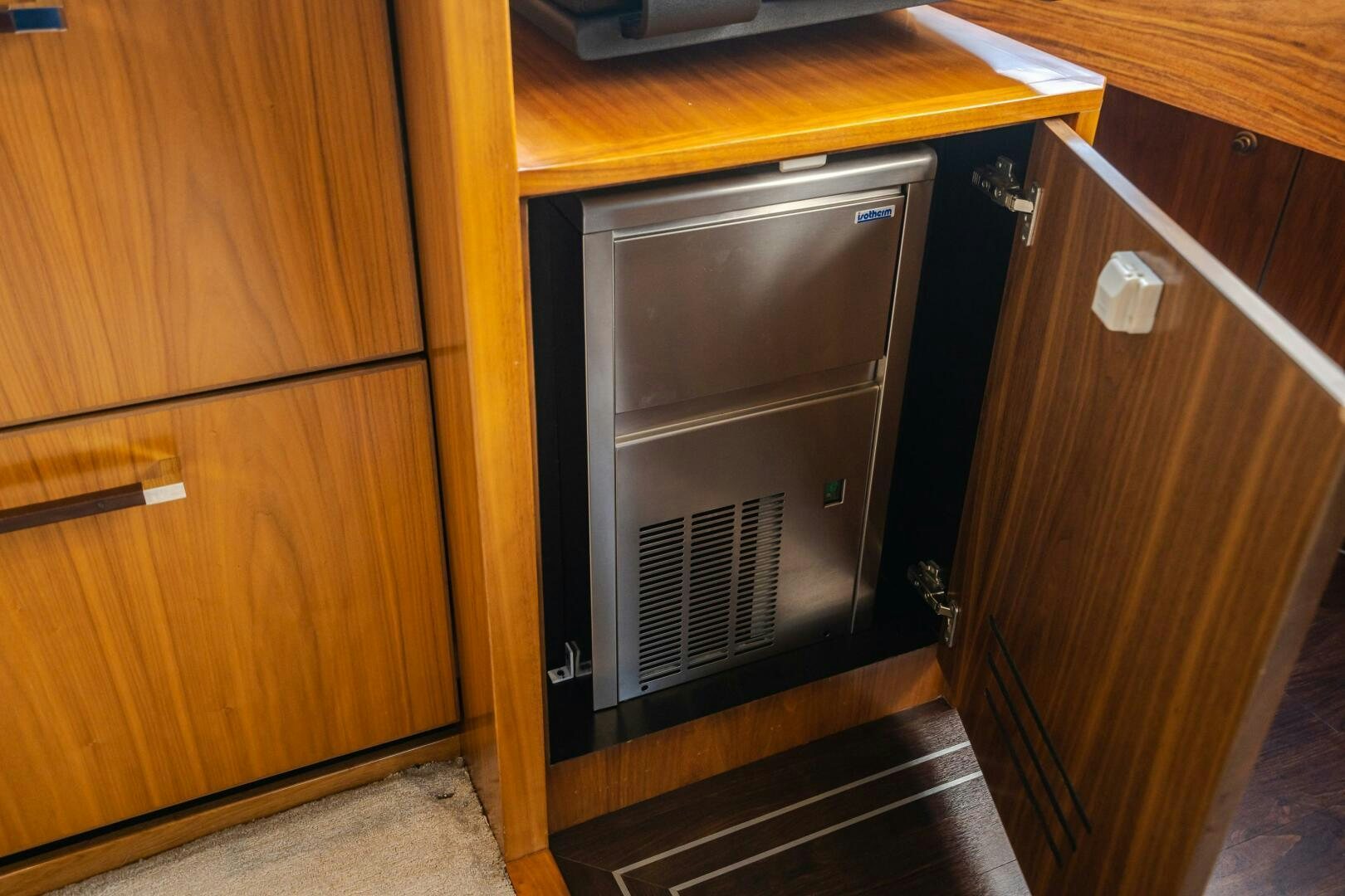 a kitchen with wooden cabinets aboard HOORAY Yacht for Sale