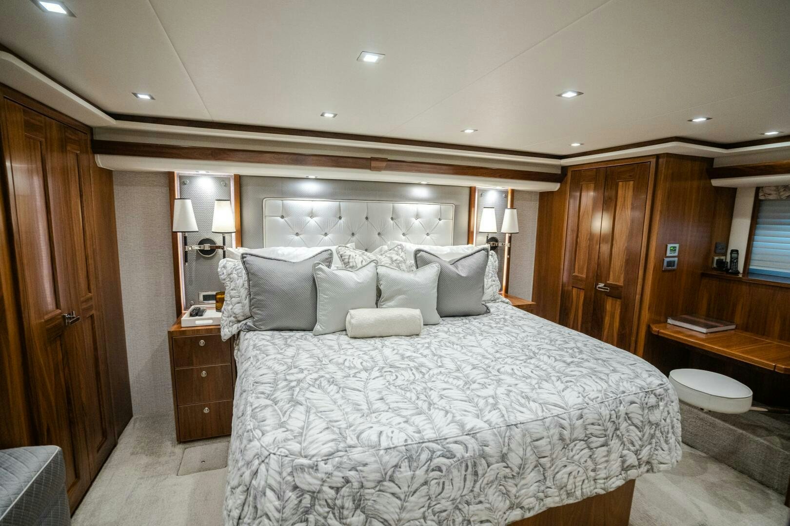 a bed with pillows and a mirror aboard HOORAY Yacht for Sale