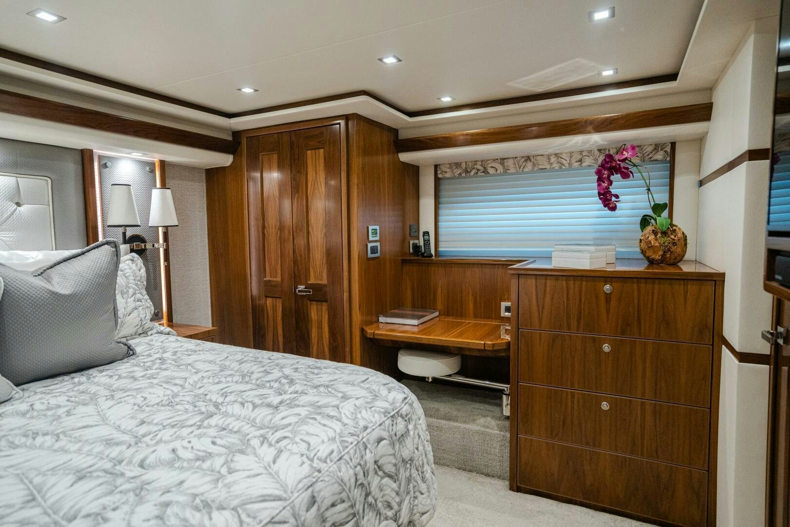 a bedroom with a bed and desk aboard HOORAY Yacht for Sale