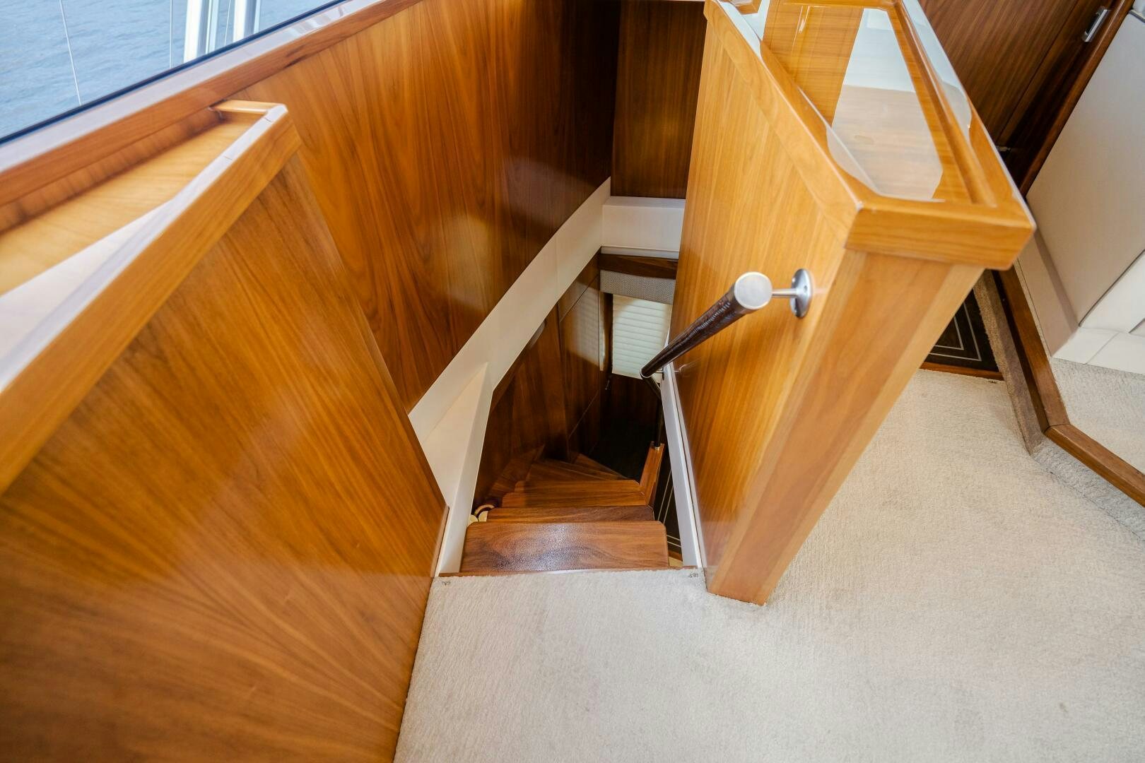 a wooden staircase with a glass door aboard HOORAY Yacht for Sale