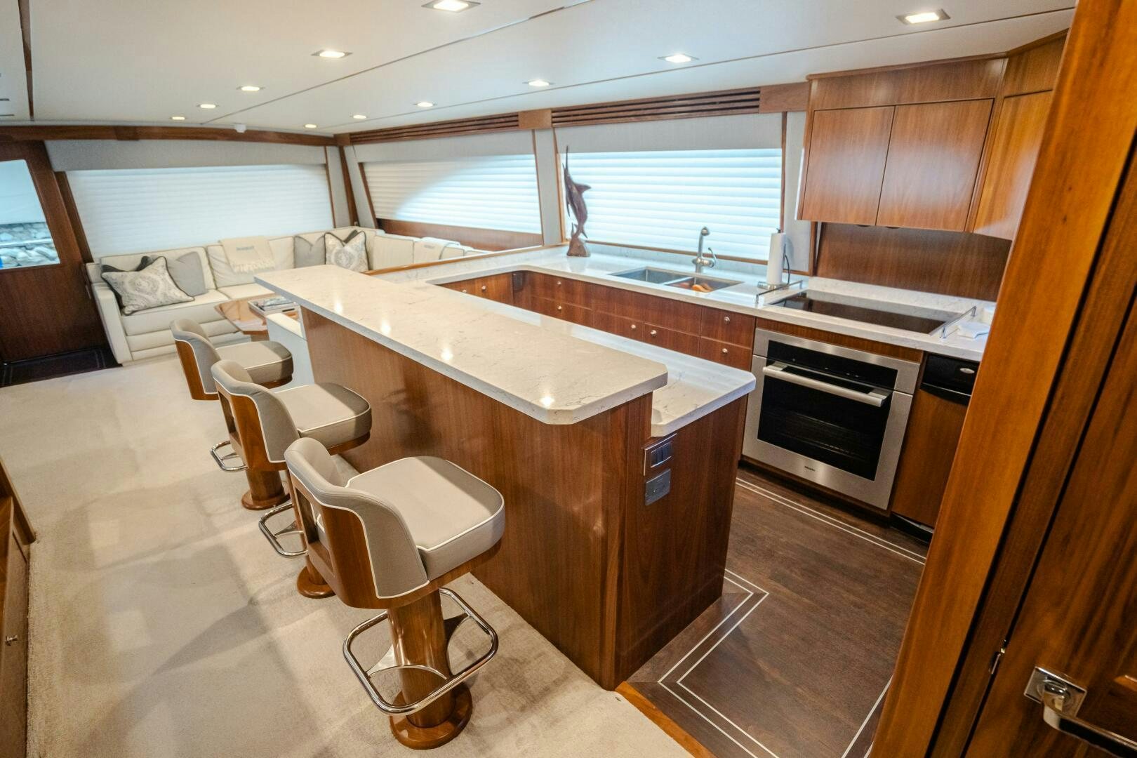 a kitchen with a bar and a table aboard HOORAY Yacht for Sale