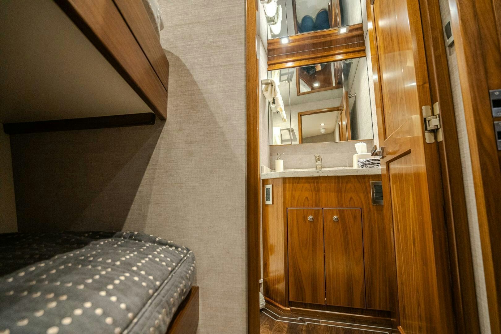 a room with a bed and a mirror aboard HOORAY Yacht for Sale