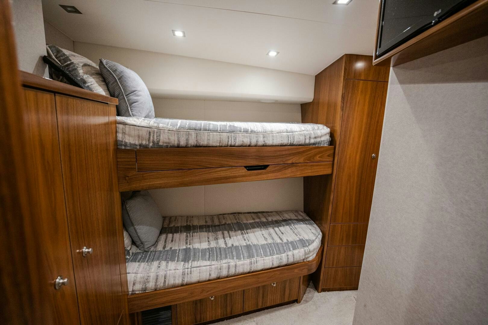 a bed with a wooden headboard aboard HOORAY Yacht for Sale