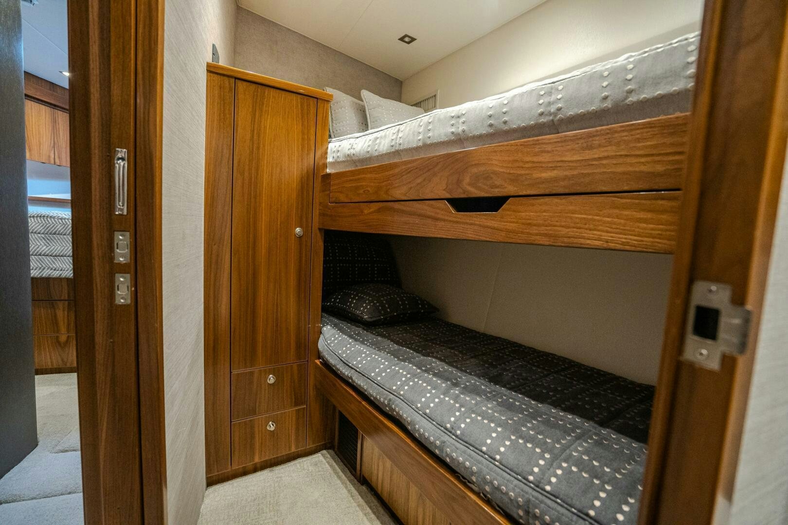 a room with a bed and a wood door aboard HOORAY Yacht for Sale