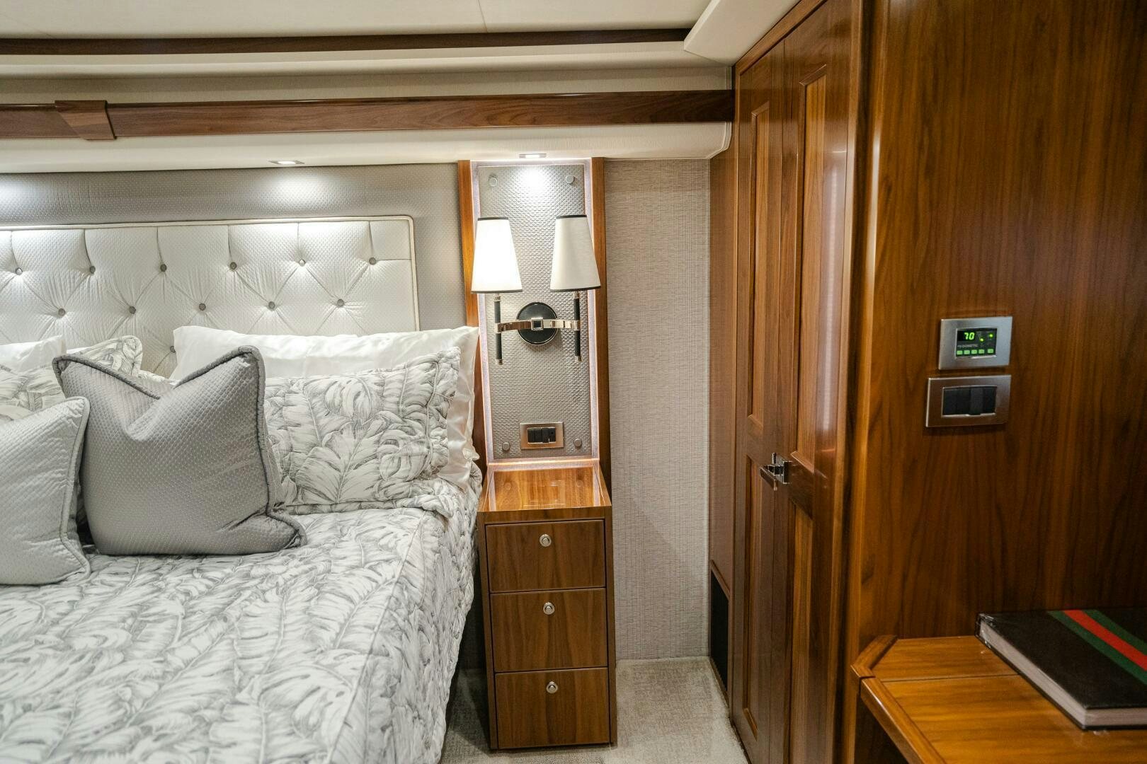 a bed with a white comforter aboard HOORAY Yacht for Sale