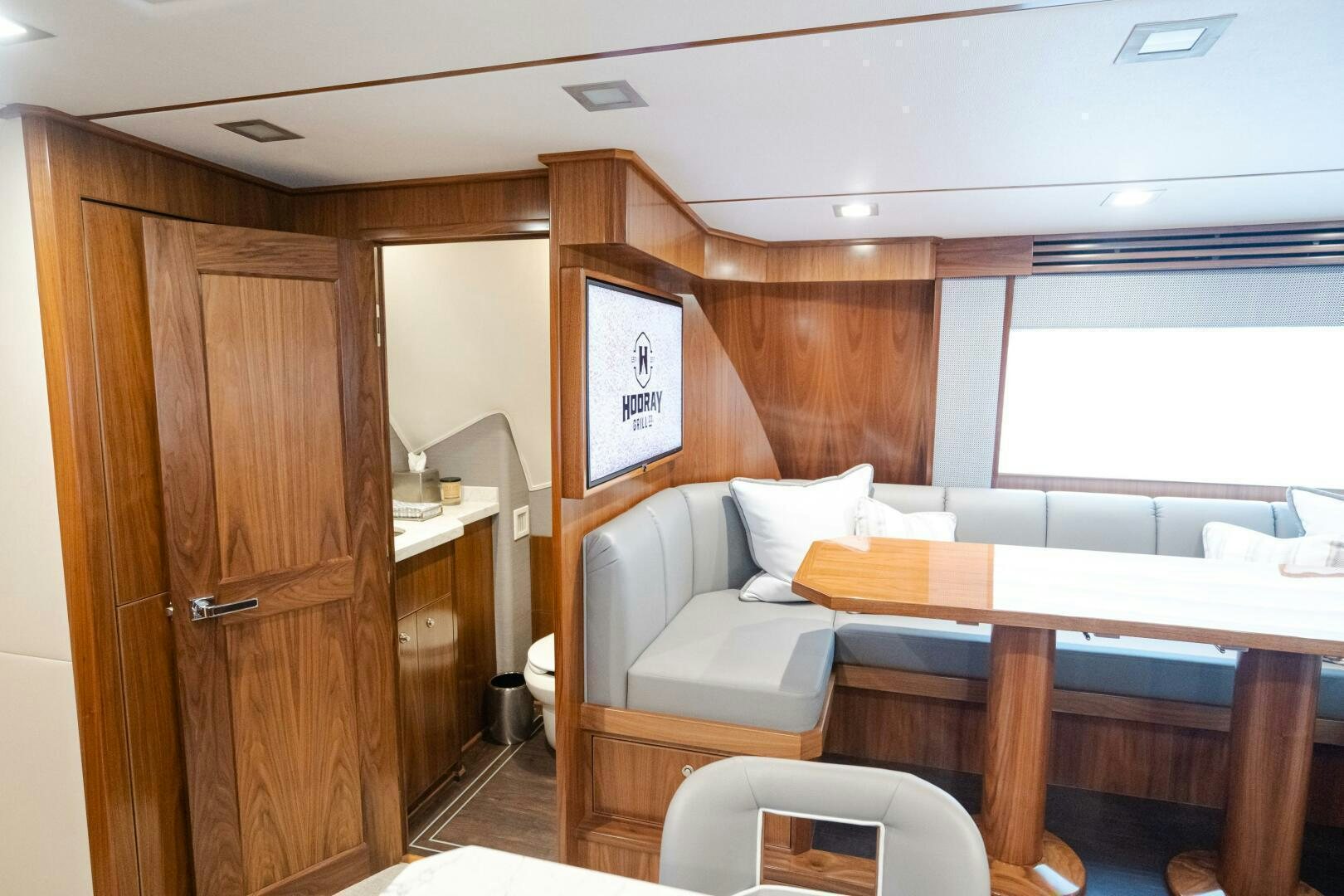 a room with a table and chairs aboard HOORAY Yacht for Sale