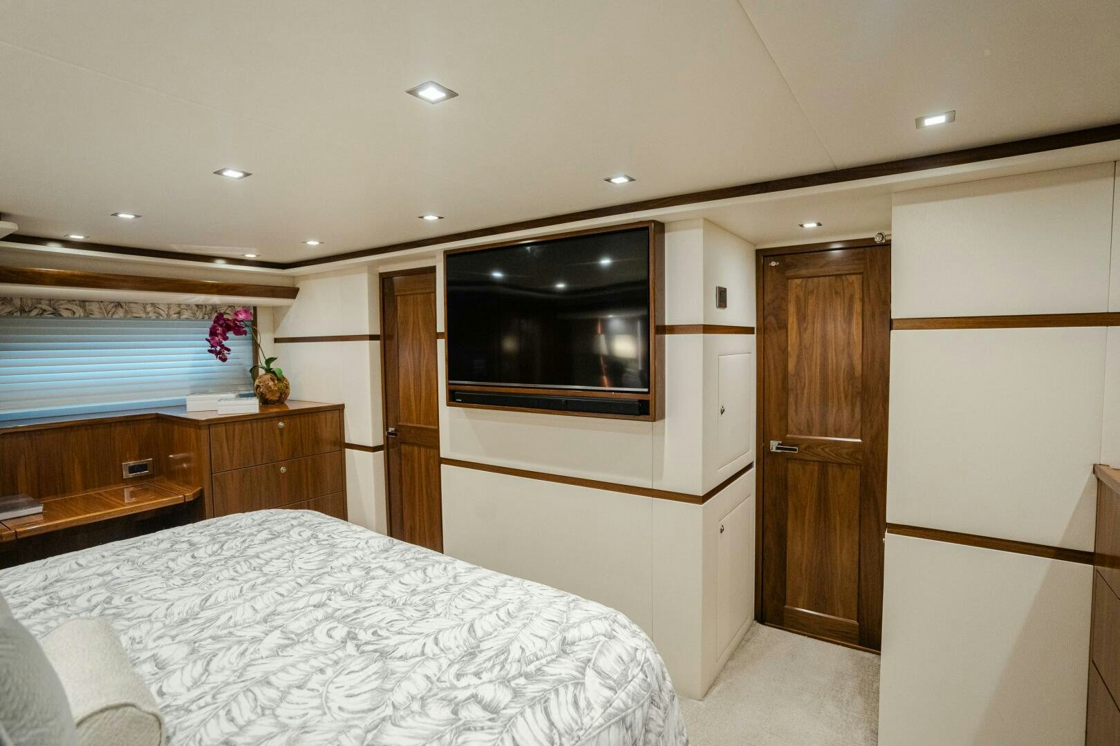 a bedroom with a bed and tv aboard HOORAY Yacht for Sale