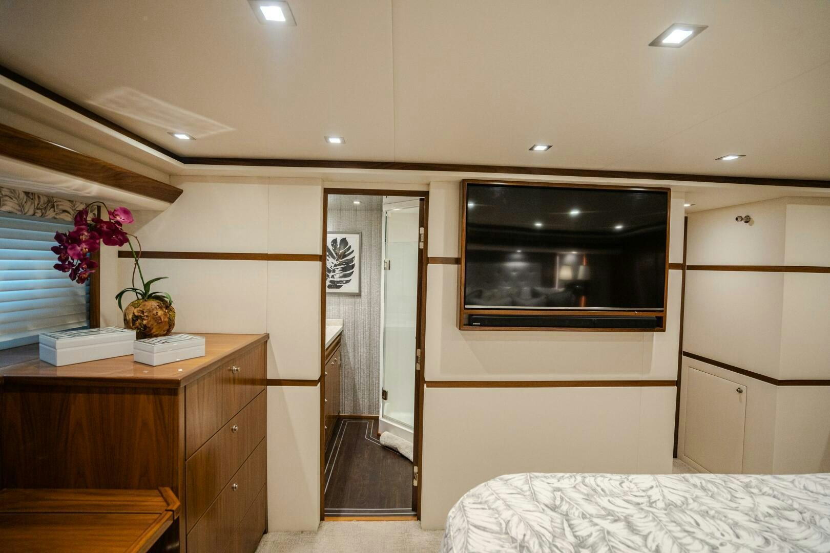 a bedroom with a tv and a bed aboard HOORAY Yacht for Sale