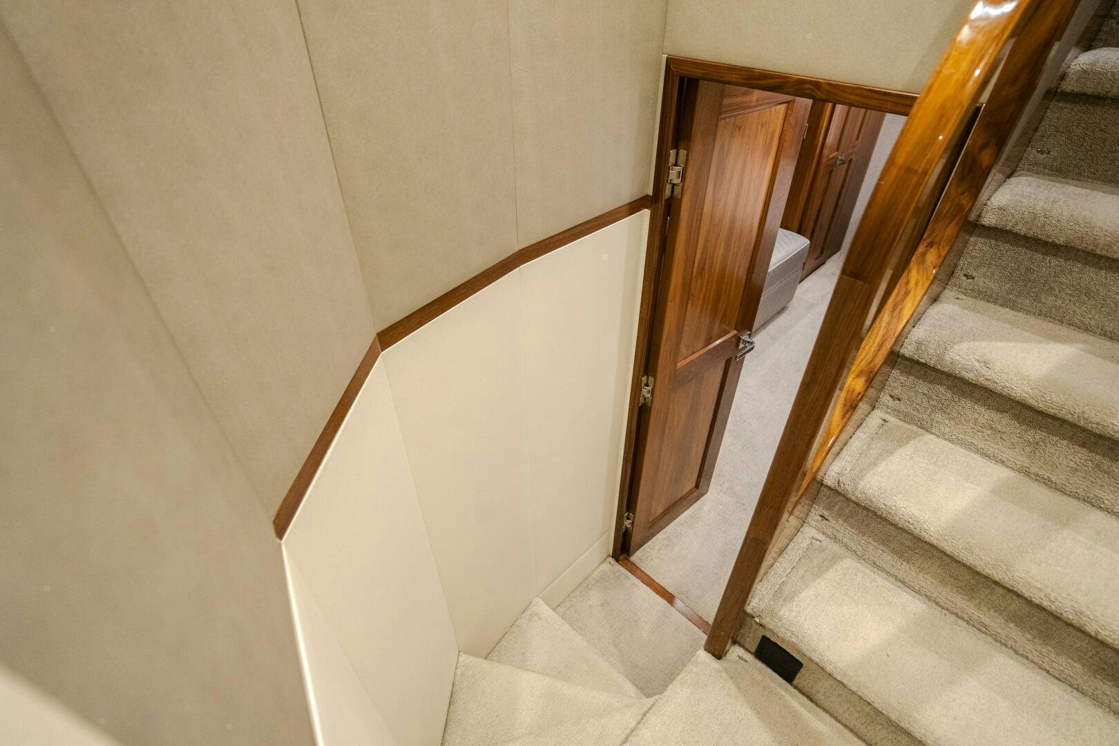 a staircase with a wood door aboard HOORAY Yacht for Sale