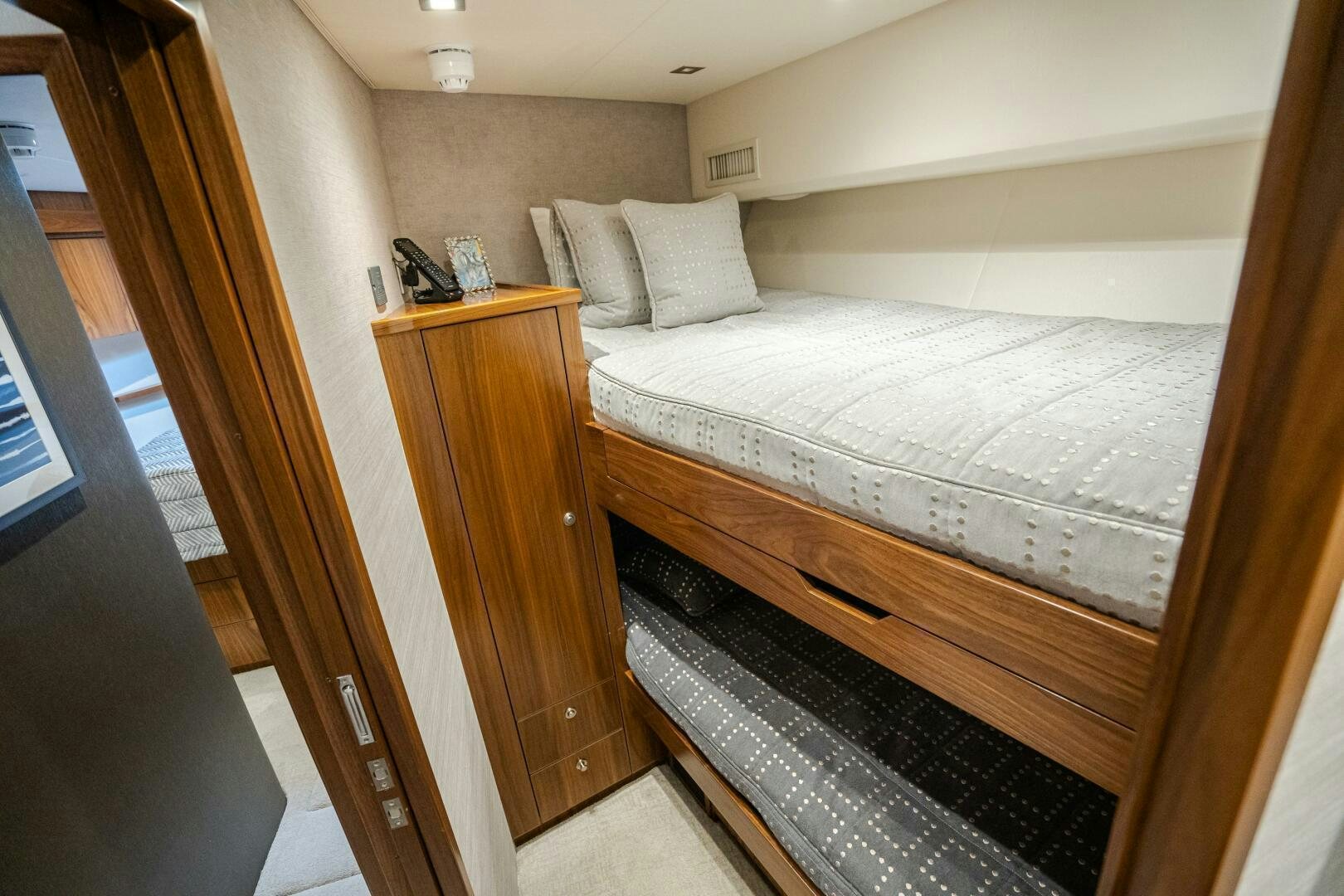 a bed with a wood headboard aboard HOORAY Yacht for Sale