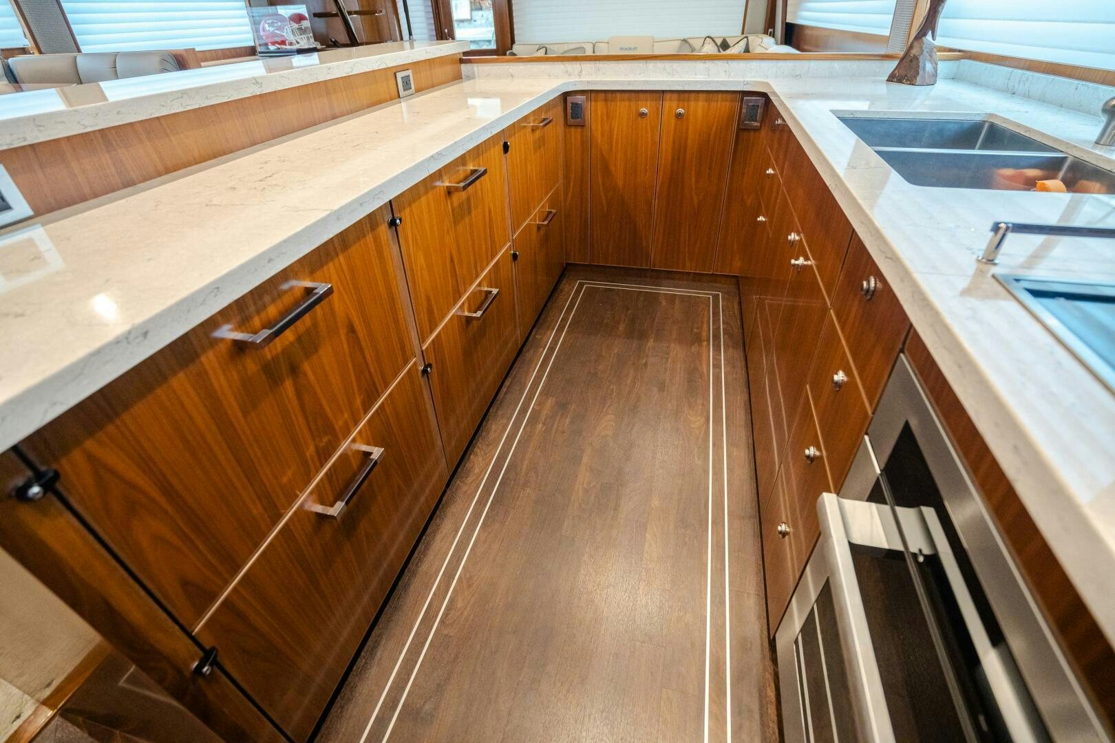 a kitchen with wooden cabinets aboard HOORAY Yacht for Sale