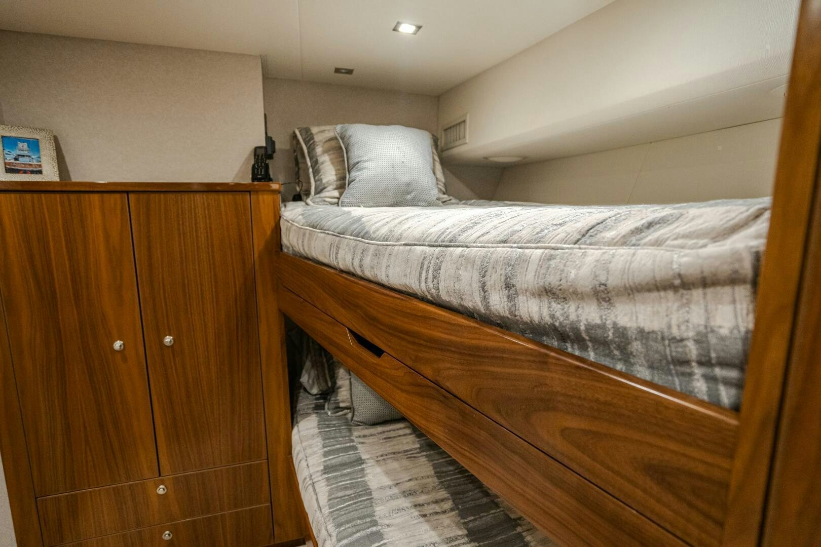 a bed with a white comforter aboard HOORAY Yacht for Sale