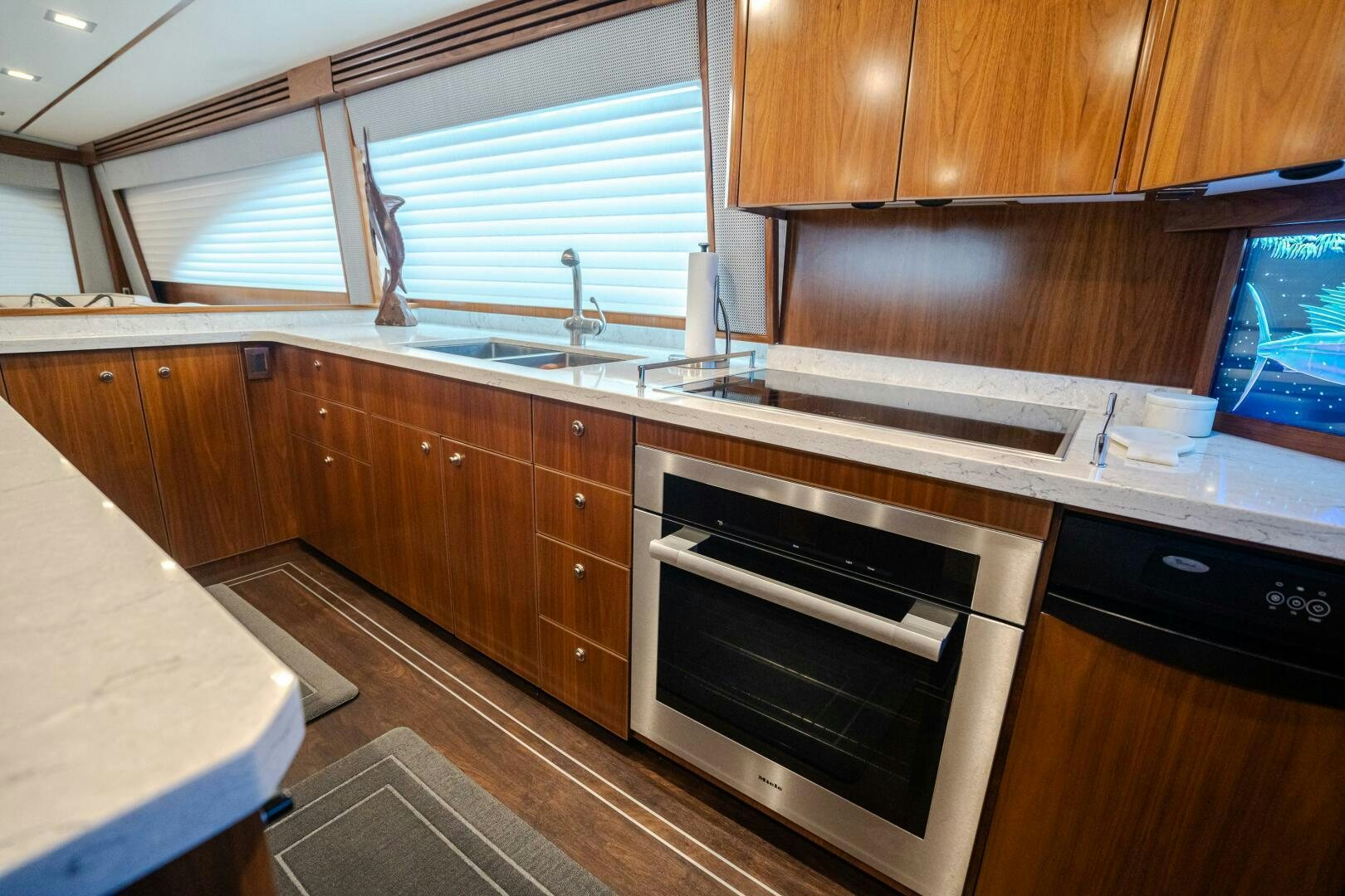 a kitchen with wooden cabinets aboard HOORAY Yacht for Sale