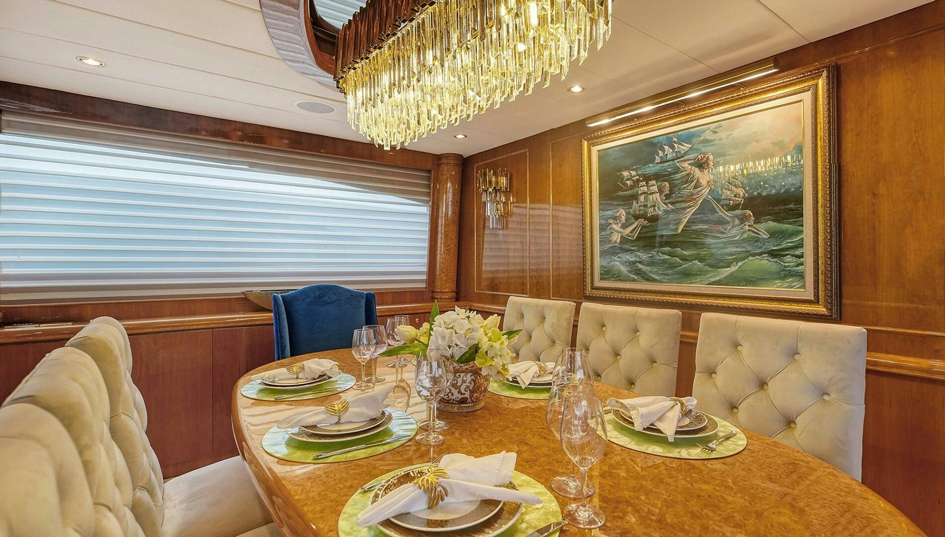 a dining table with plates and glasses aboard FANTASEA Yacht for Sale