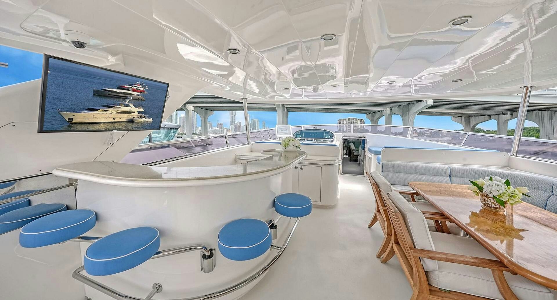 a room with tables and chairs aboard FANTASEA Yacht for Sale