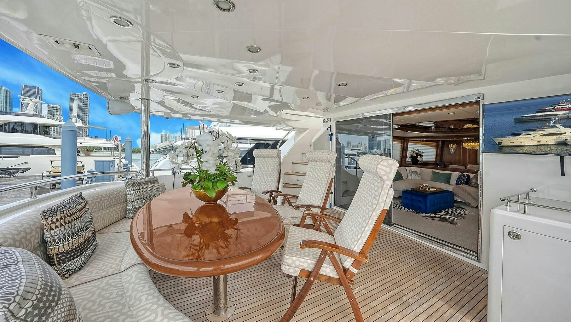 a room with a table chairs and a plant on the table aboard FANTASEA Yacht for Sale