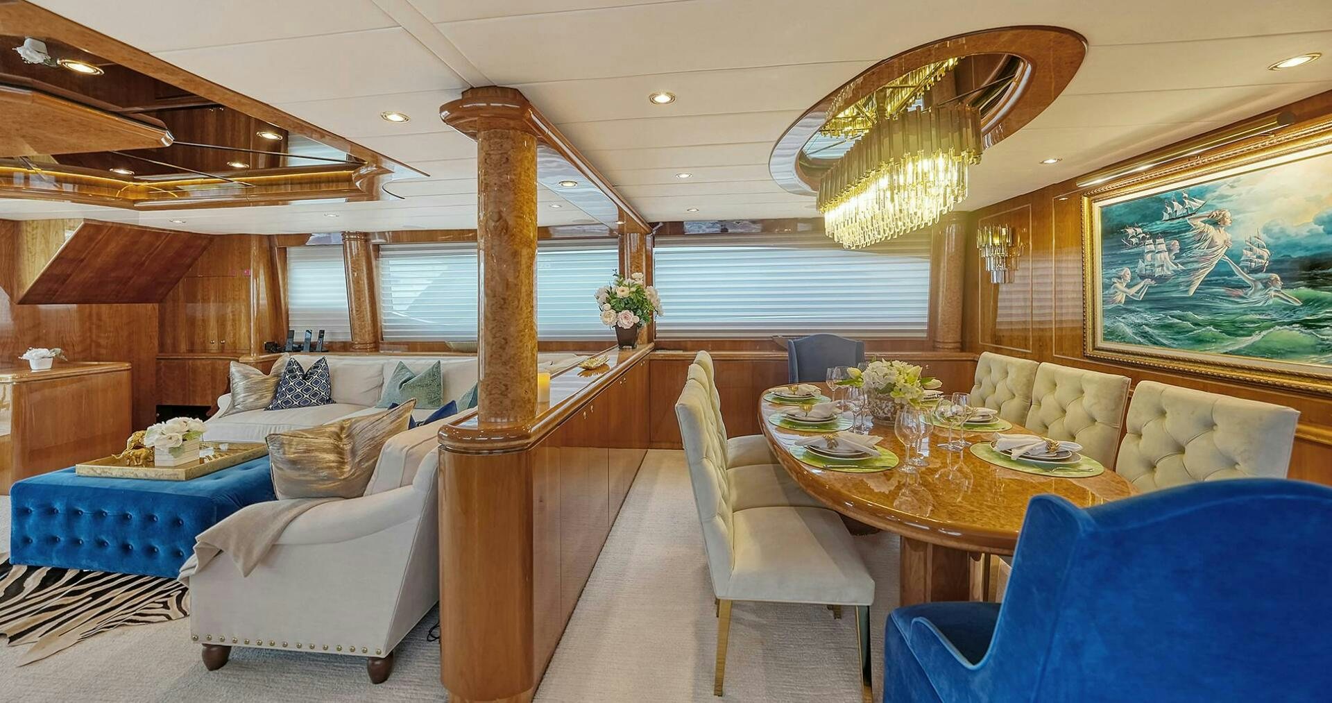 a room with a table and chairs aboard FANTASEA Yacht for Sale
