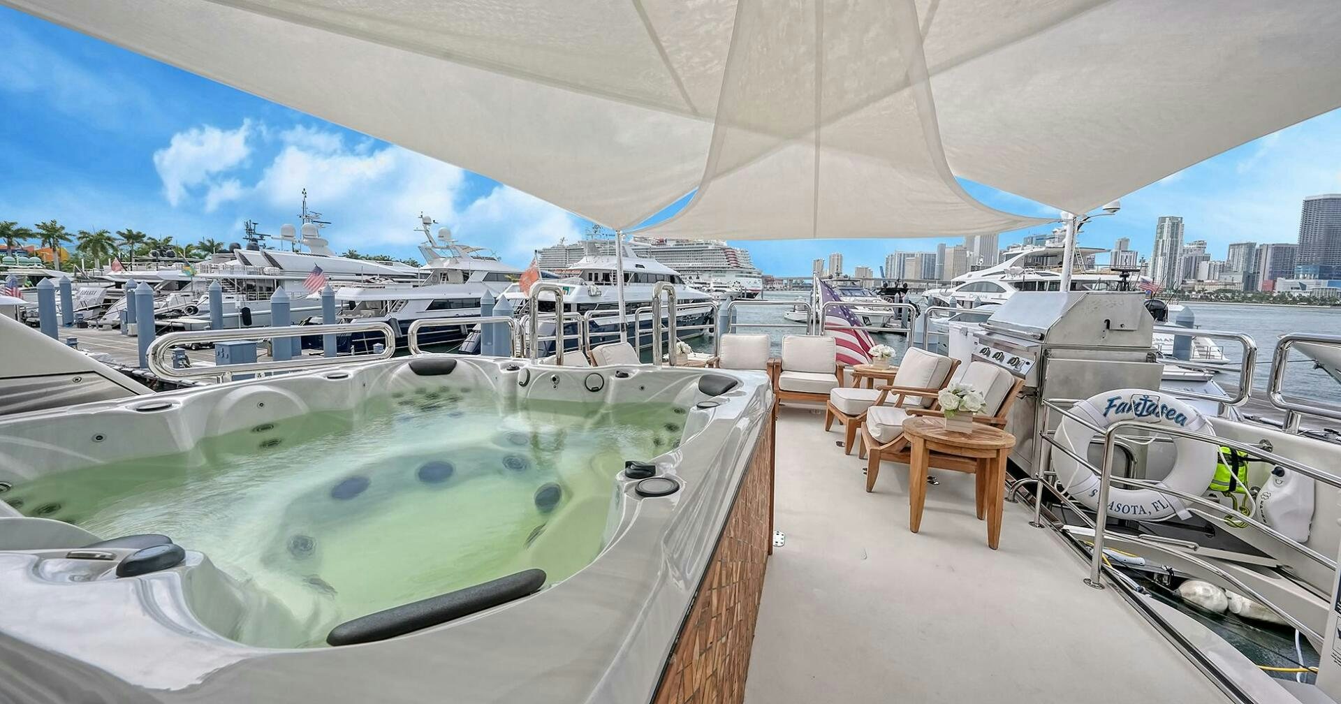 a large pool with chairs around it aboard FANTASEA Yacht for Sale