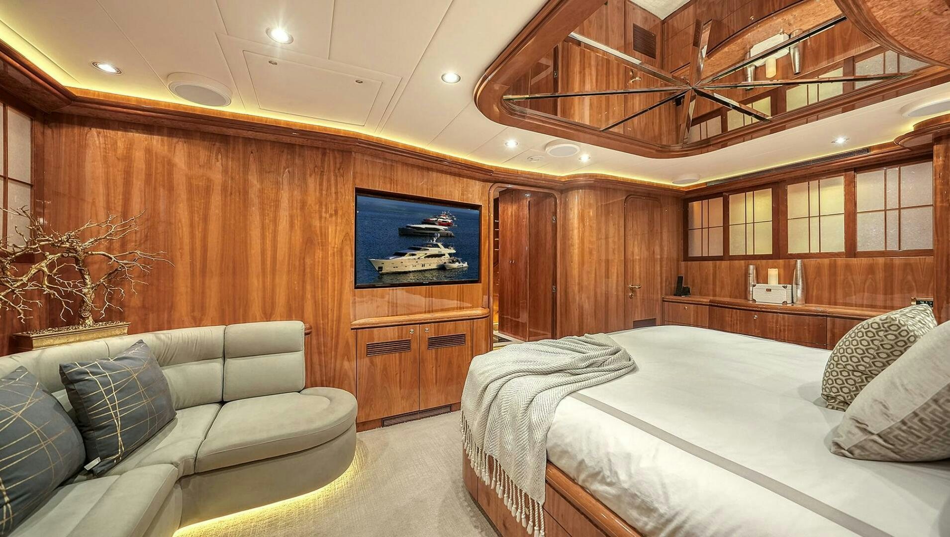 a room with a bed and a couch aboard FANTASEA Yacht for Sale
