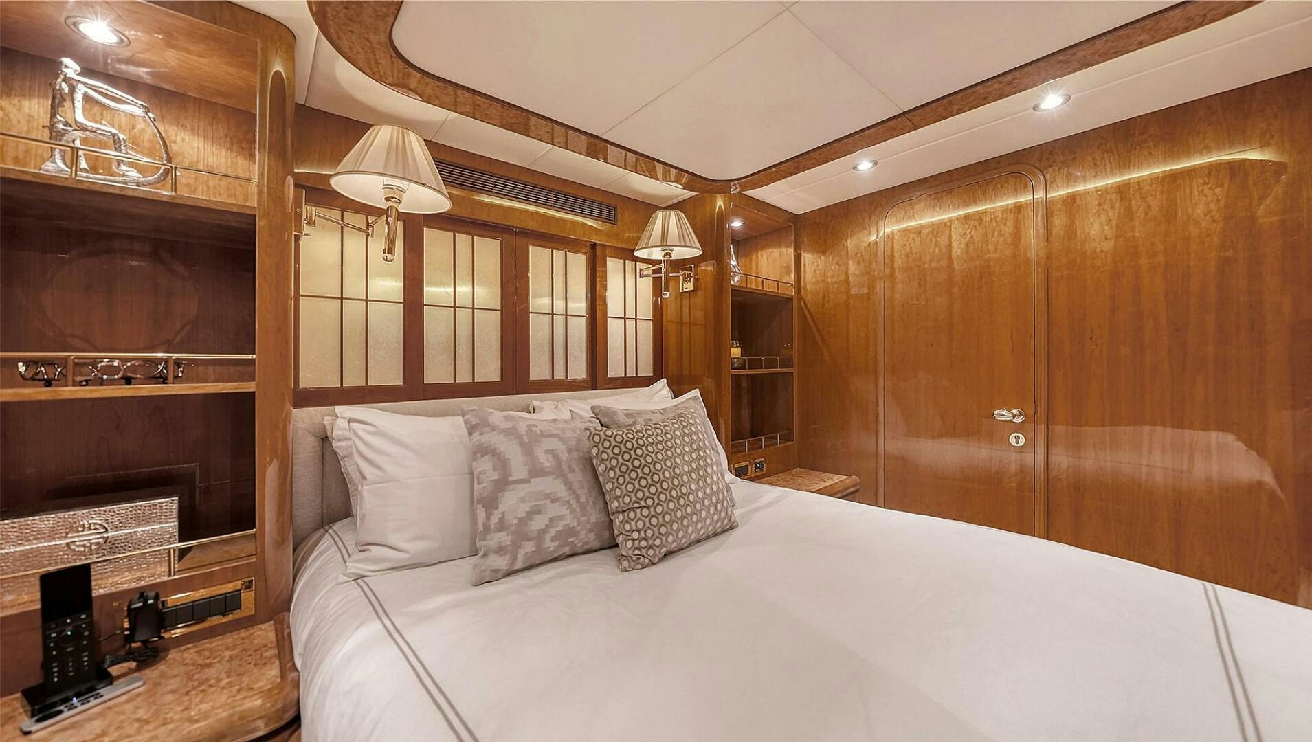 a bed with pillows and a mirror aboard FANTASEA Yacht for Sale