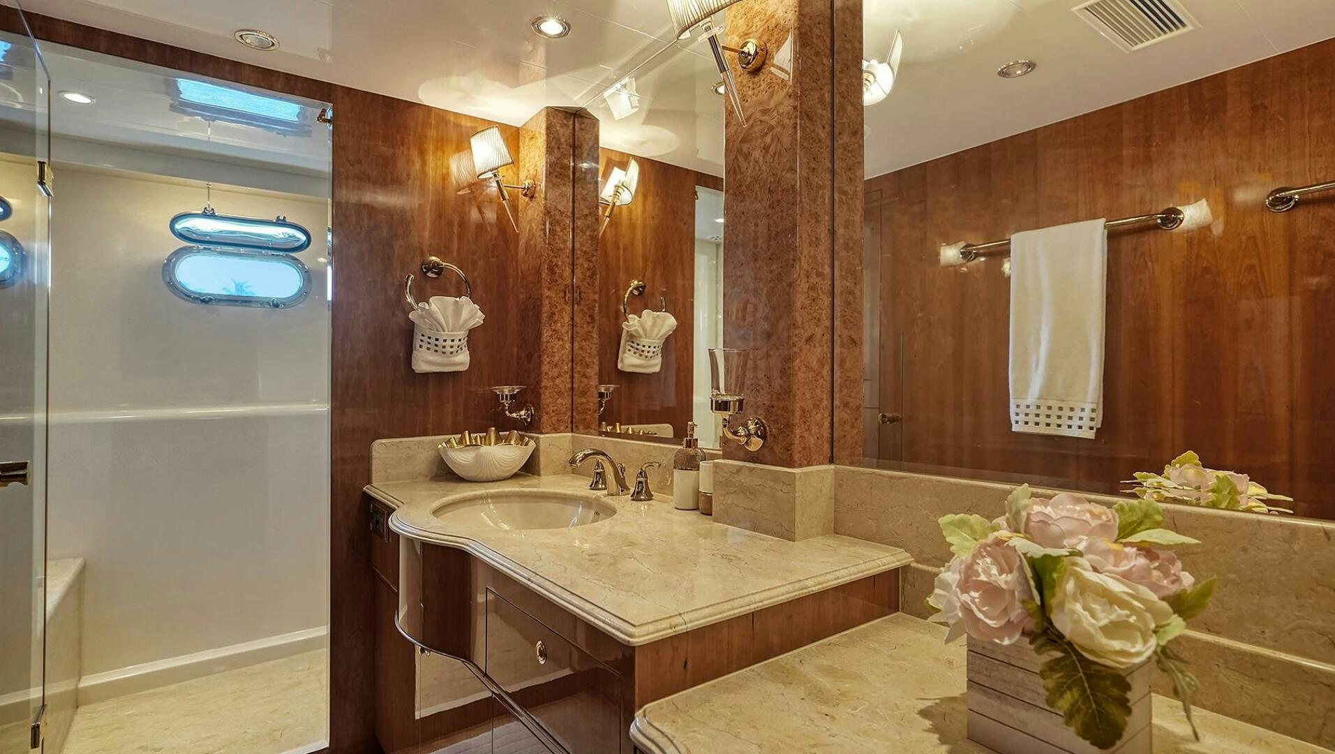 a bathroom with a countertop sink and a large mirror aboard FANTASEA Yacht for Sale