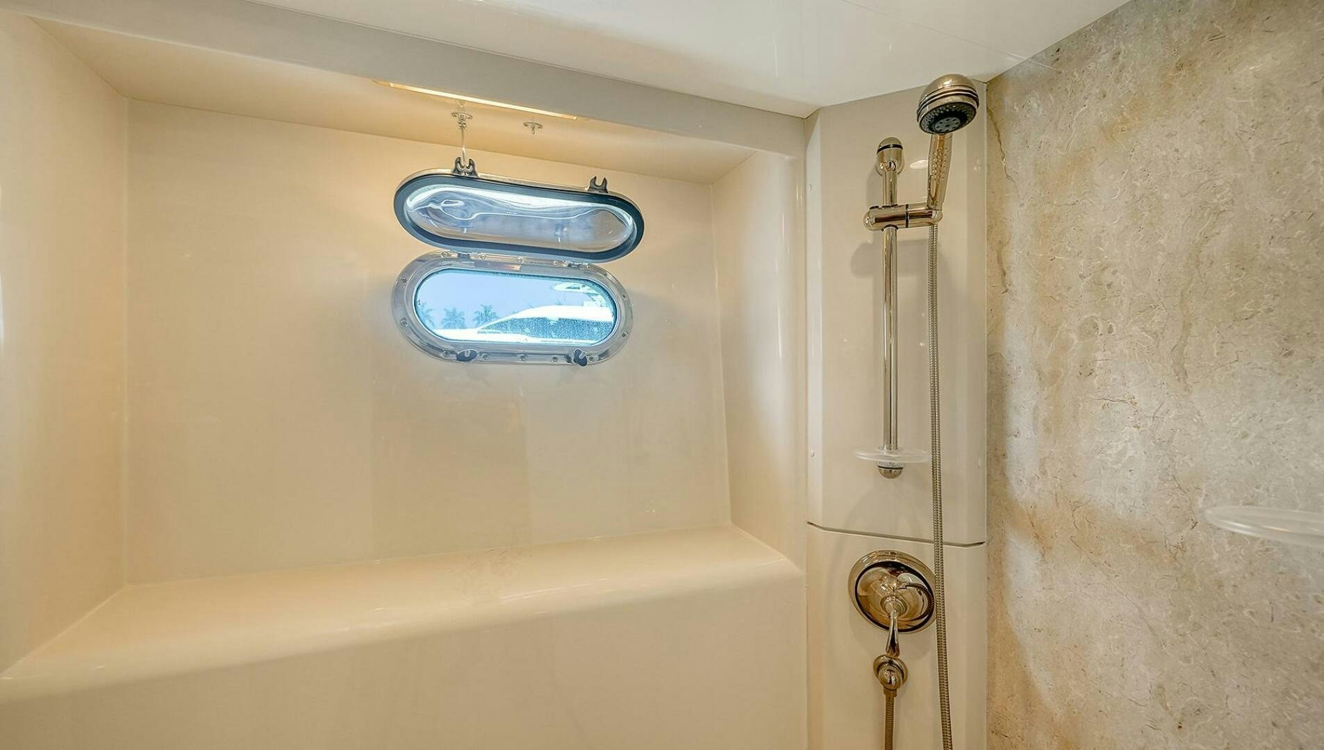 a bathtub with a blue soap dispenser aboard FANTASEA Yacht for Sale