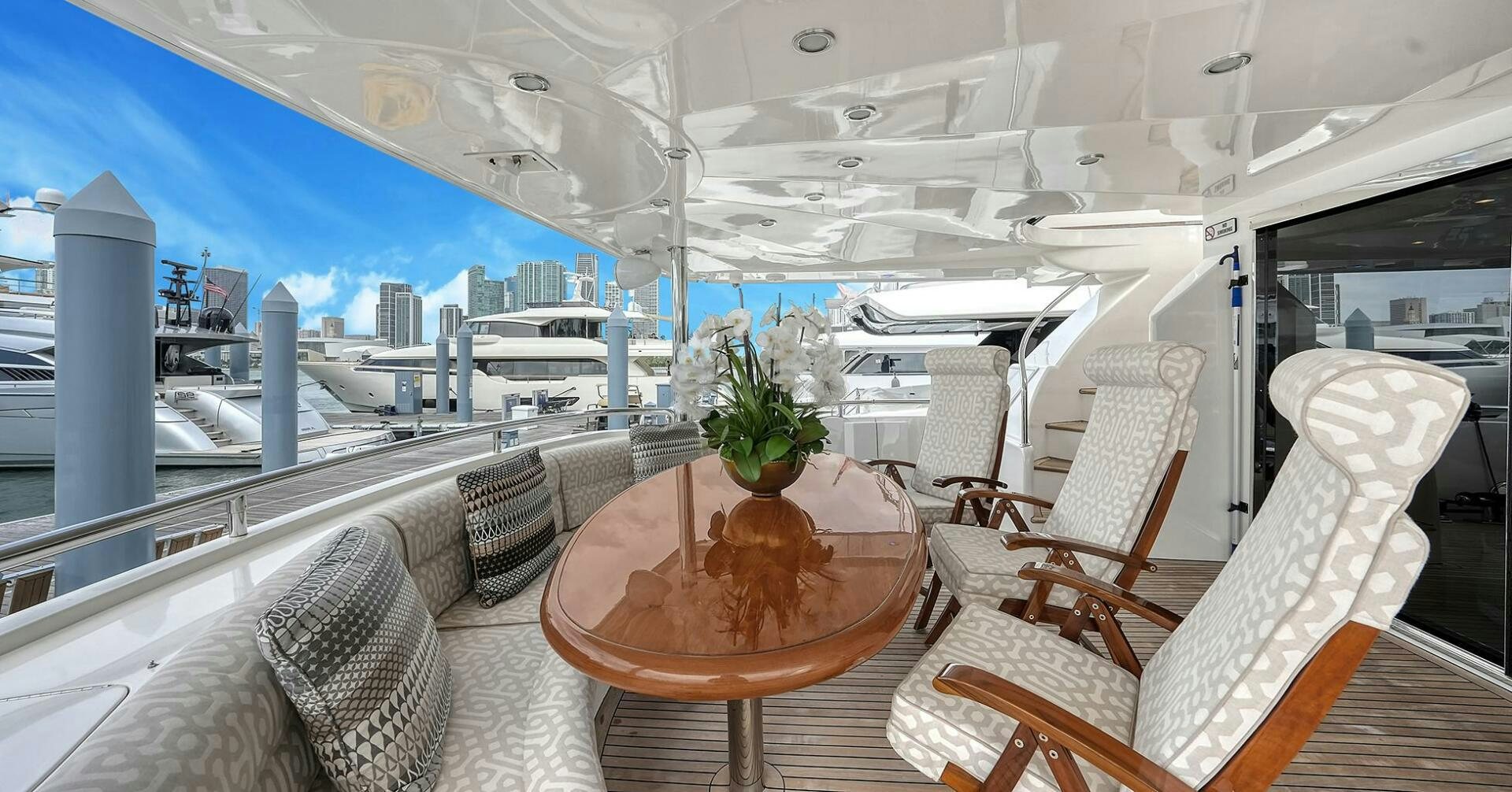 a table with chairs on it aboard FANTASEA Yacht for Sale
