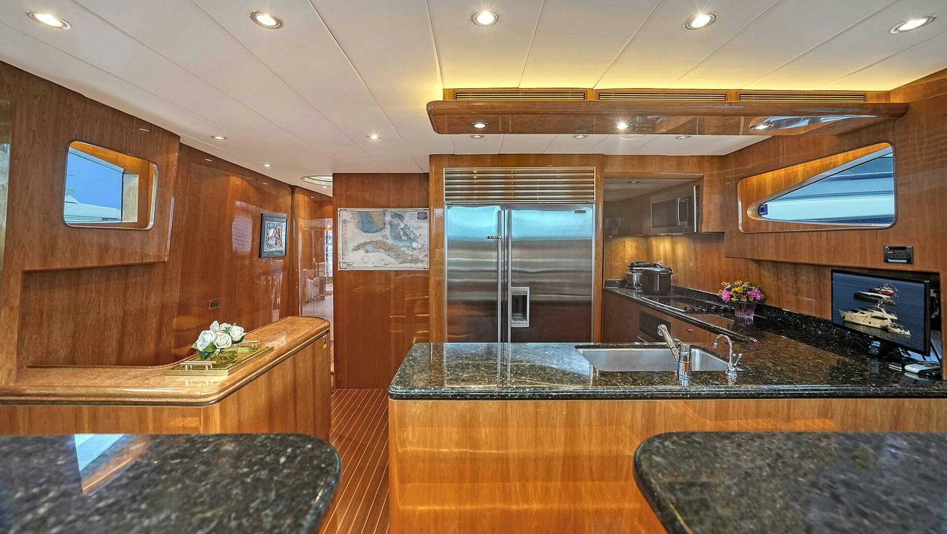 a kitchen with a bar and a bar aboard FANTASEA Yacht for Sale