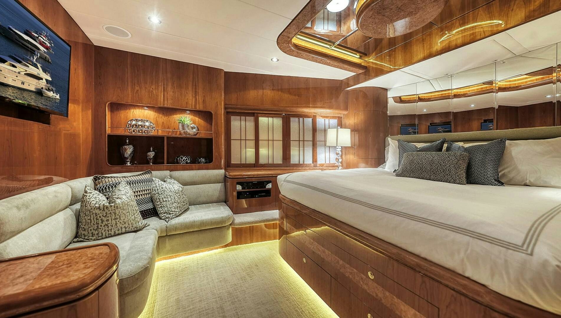 a large bedroom with a bed and a couch aboard FANTASEA Yacht for Sale