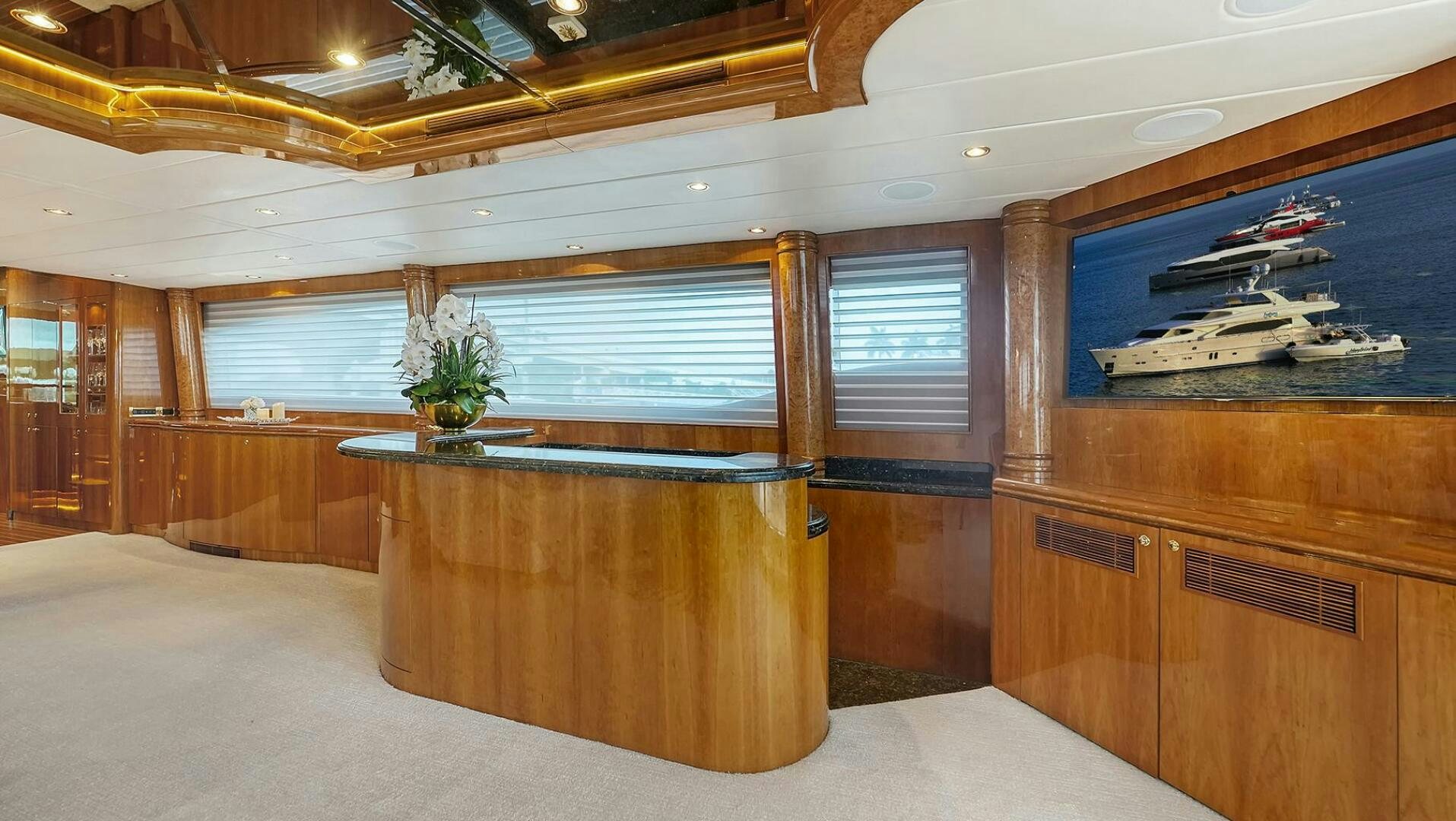 a room with a table and a plant in it aboard FANTASEA Yacht for Sale