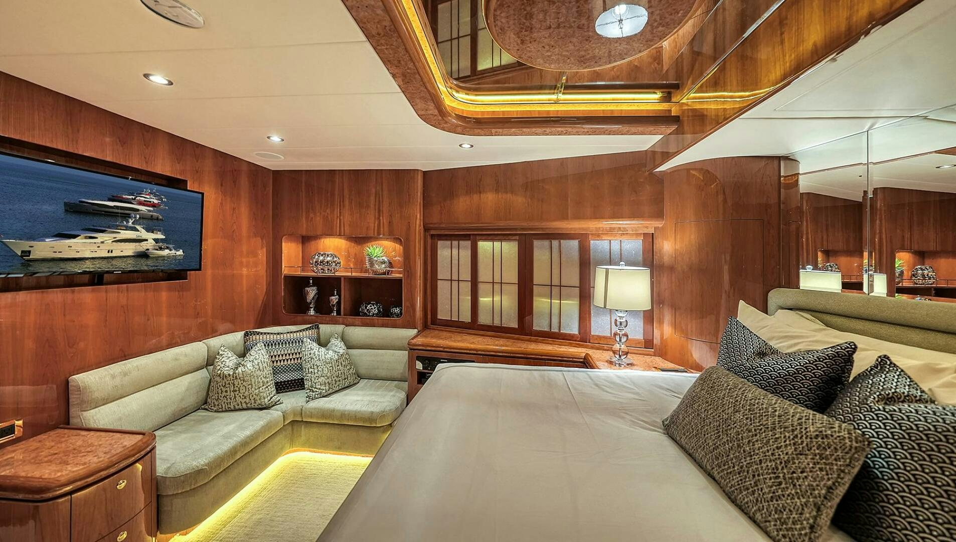 a living room with a large sofa aboard FANTASEA Yacht for Sale