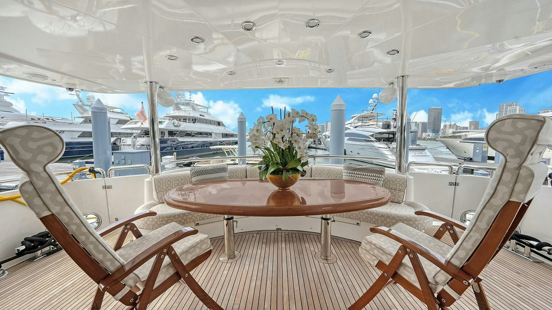 a room with a table and chairs aboard FANTASEA Yacht for Sale