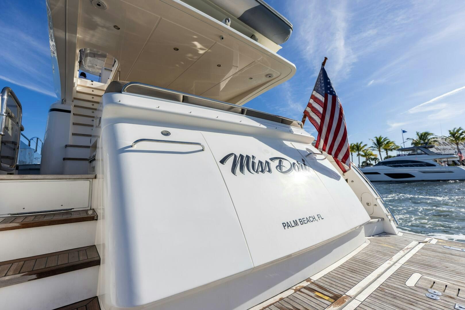 a boat with a flag on the front aboard MISS DORI Yacht for Sale