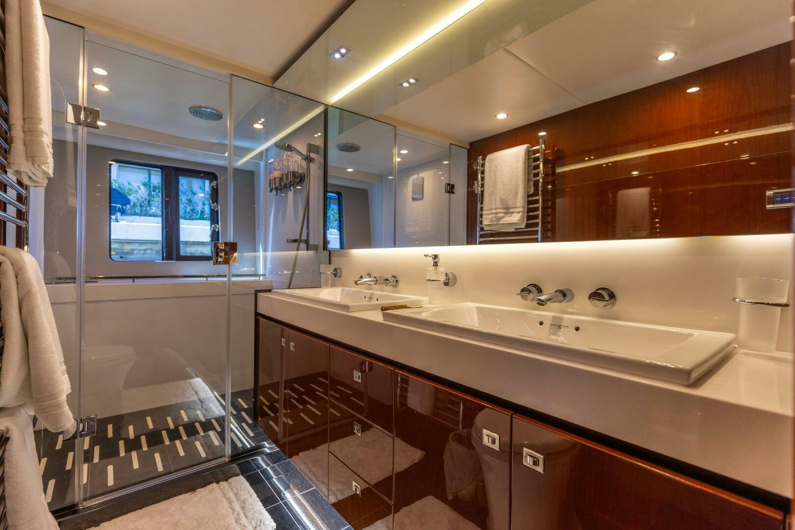 a bathroom with a large mirror aboard MISS DORI Yacht for Sale