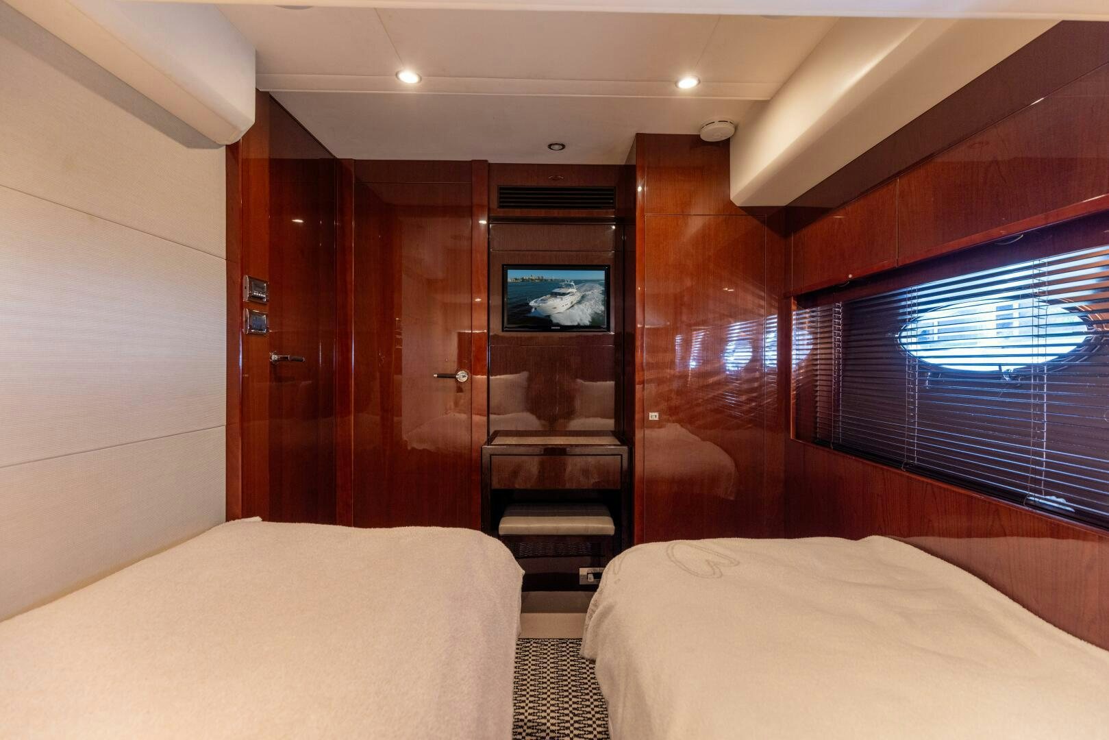 a room with a bed and a tv on the wall aboard MISS DORI Yacht for Sale