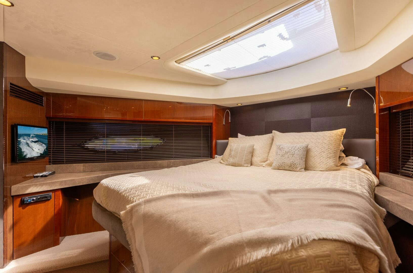 a bed with a television on the wall aboard MISS DORI Yacht for Sale