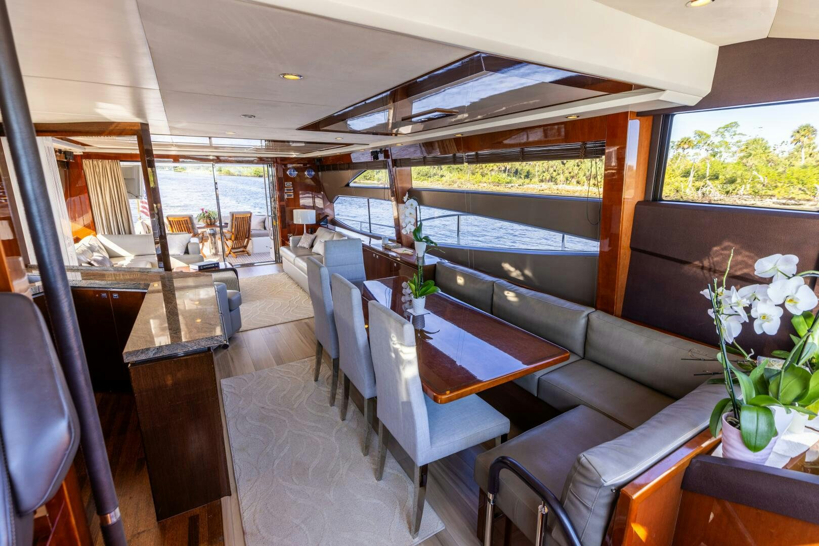 a room with a couch and a table and chairs aboard MISS DORI Yacht for Sale
