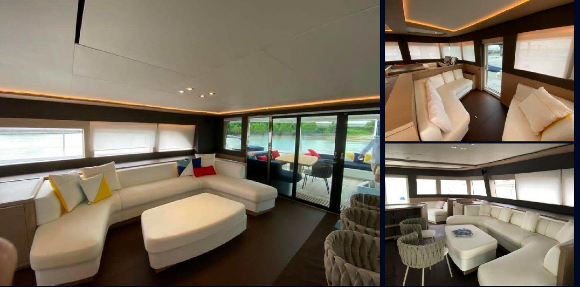 a room with a couch and a table and chairs aboard HTC Yacht for Sale