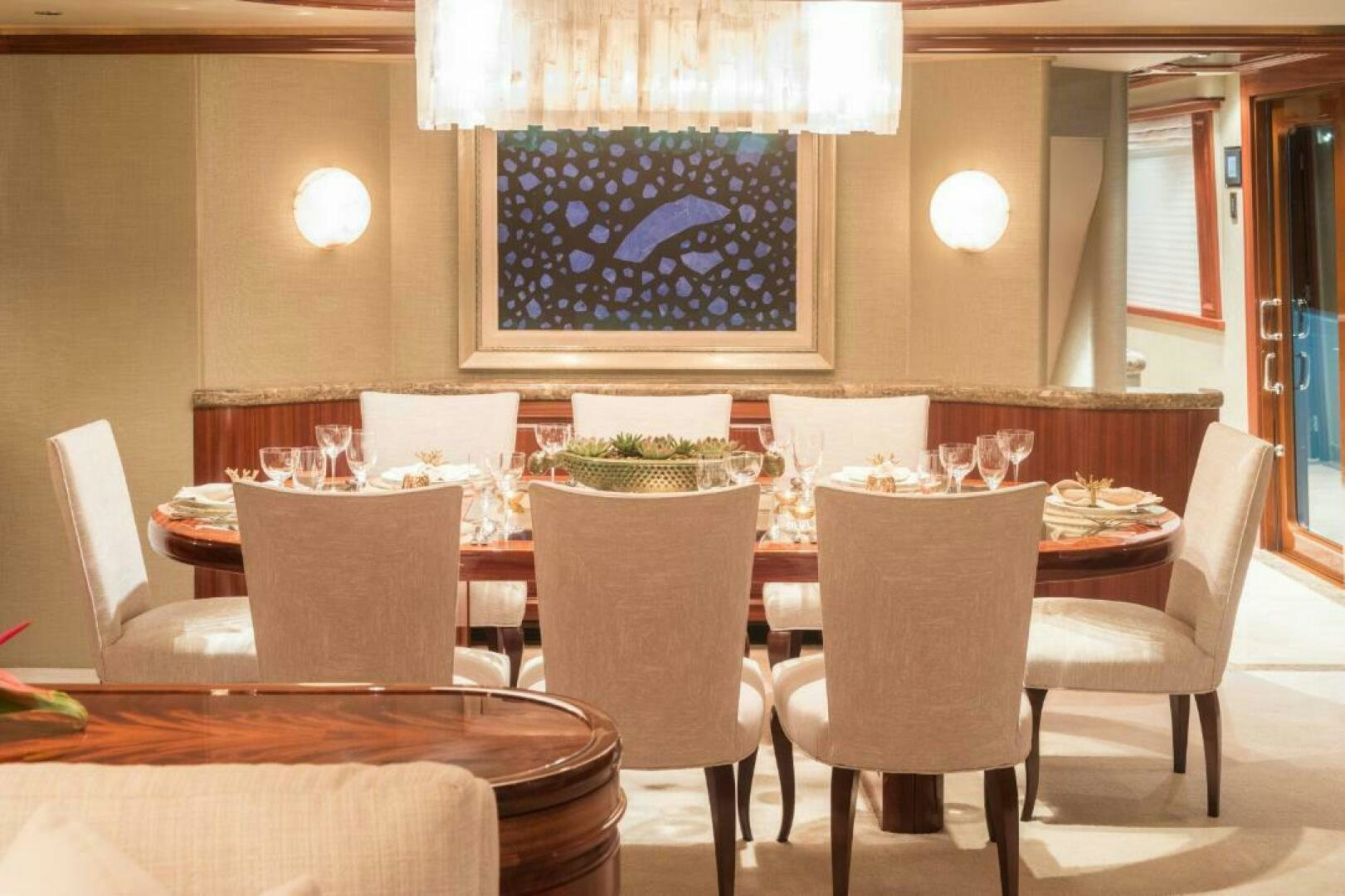a dining room table with chairs and a large chandelier aboard TRUST FUN Yacht for Sale