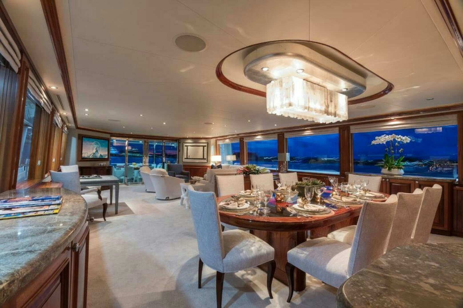 a large room with a table and chairs aboard TRUST FUN Yacht for Sale