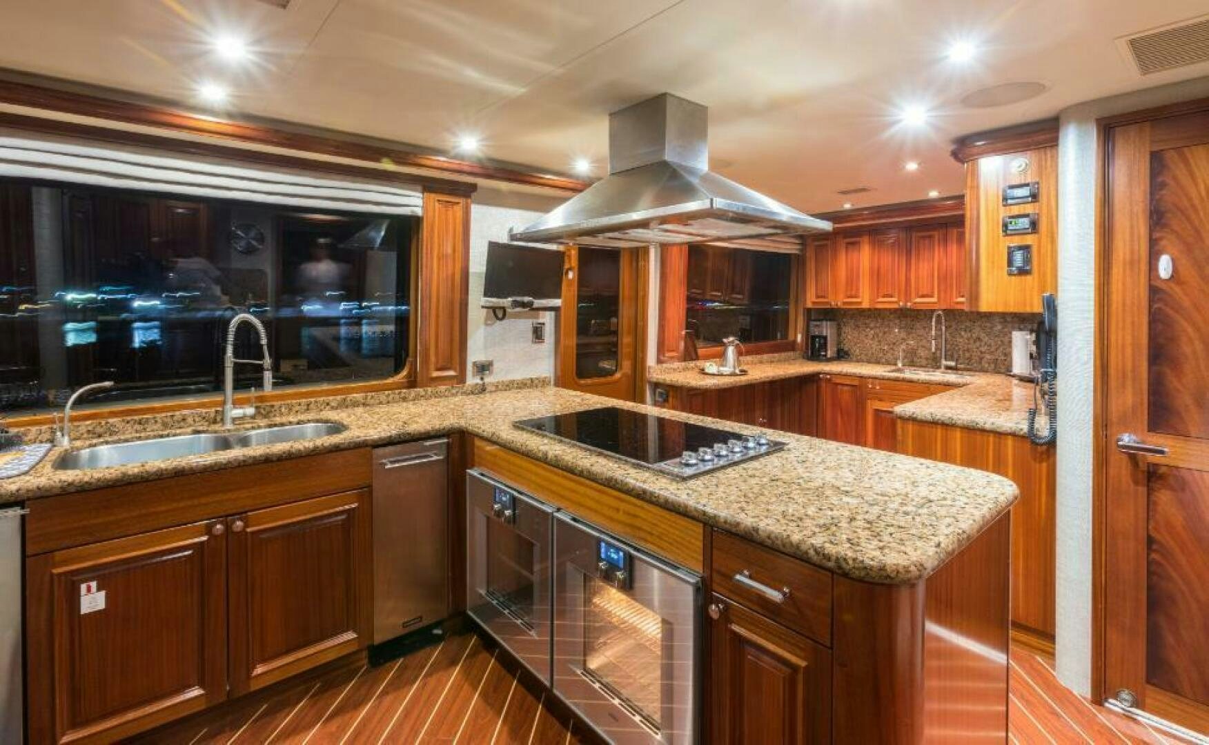 a kitchen with wooden cabinets aboard TRUST FUN Yacht for Sale